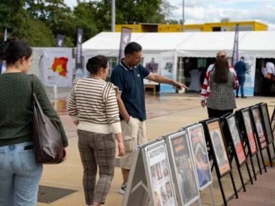 Pedestrians in front of GHRD Exhibition in United Nations in Geneva, Zwitserland