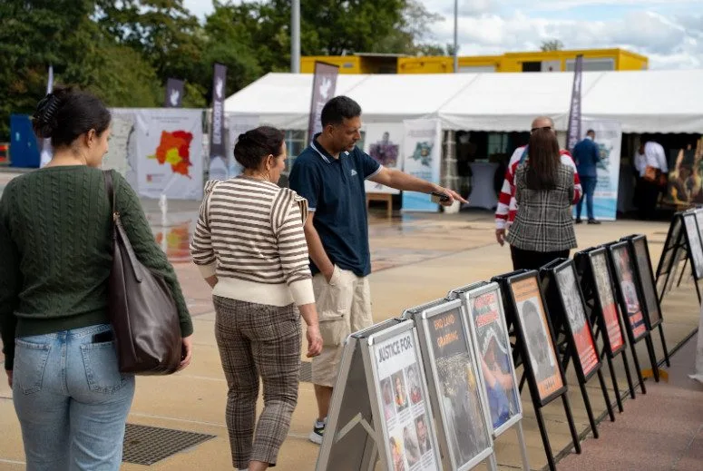 Pedestrians in front of GHRD Exhibition in United Nations in Geneva, Zwitserland